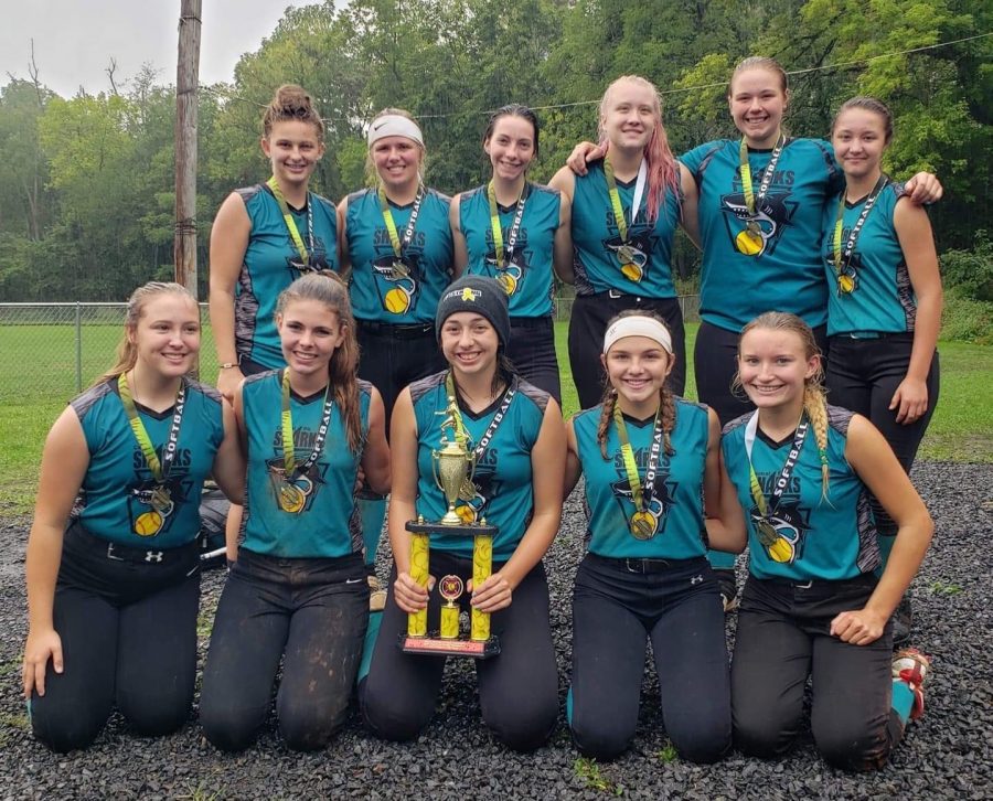 Ellie Coursen (front center) captures a tournament win with her travel softball team.